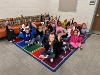 Elementary students working together in the school media center